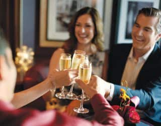 A group of people celebrating New Year’s eve on a Holland America Line New Year’s Cruise