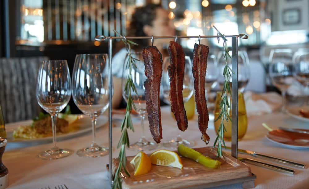 David Burke's Clothesline Candied Bacon is a must at Pinnacle Grill. 