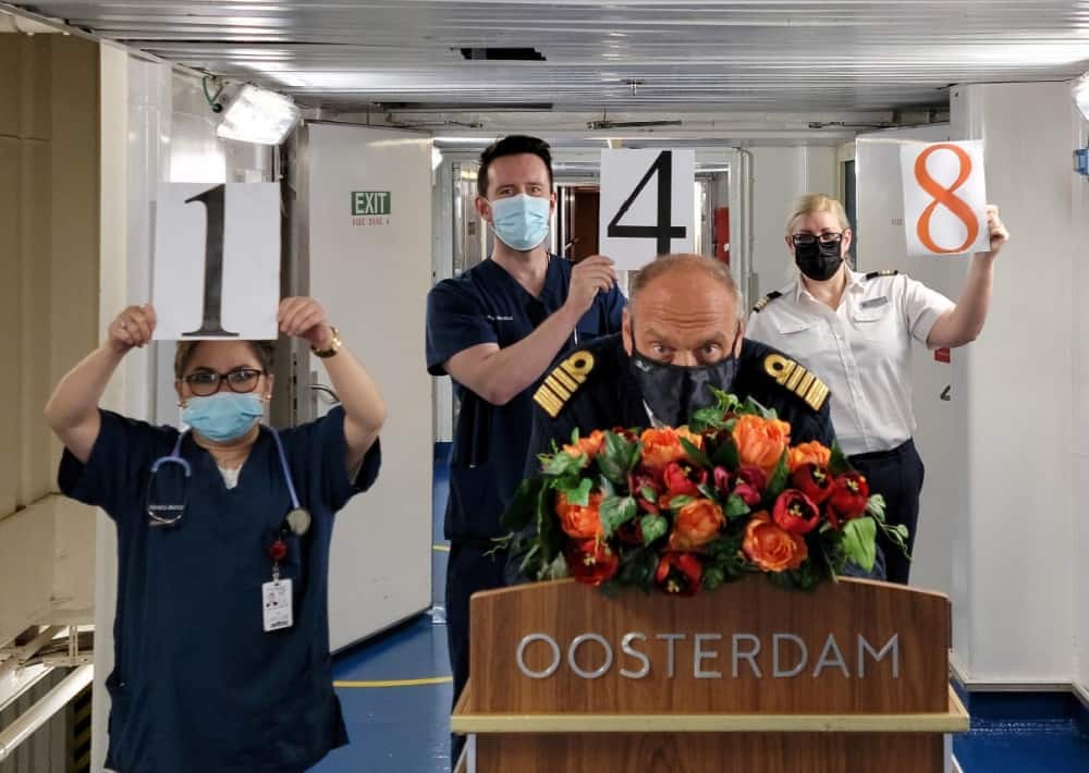 Oosterdam's captain and team members celebrate our 148th!
