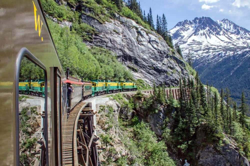 White Pass & Yukon Route Railroad travels along the cliffs heading towards Skagway, Alaska