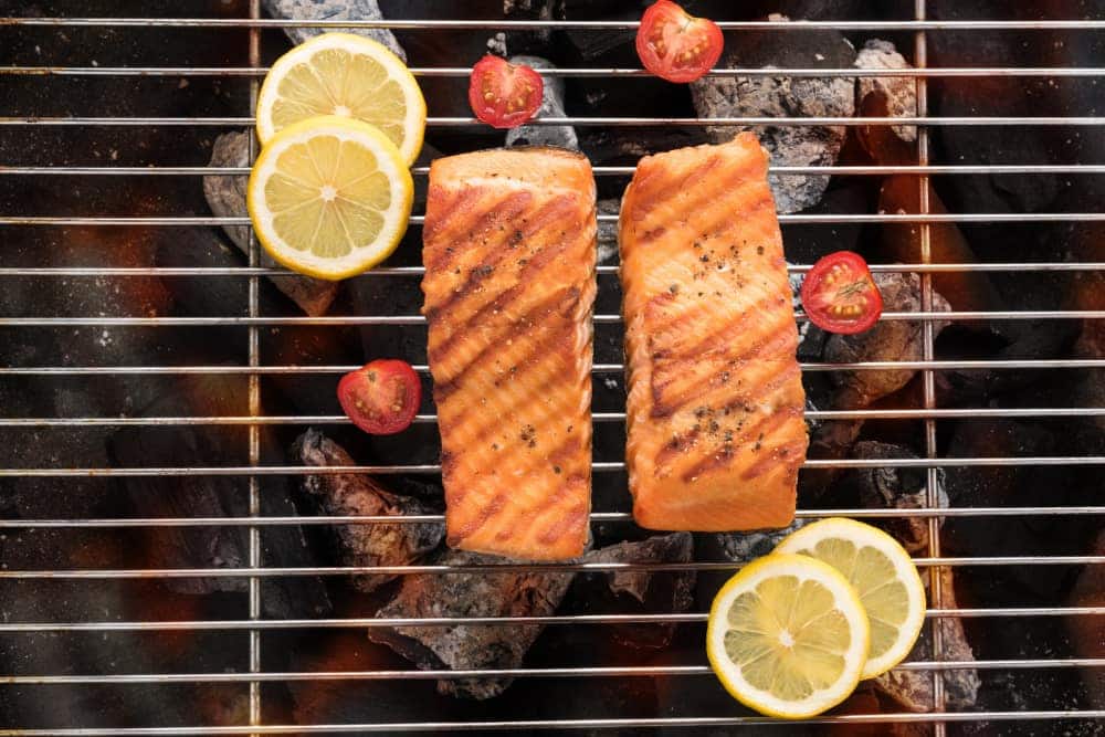 Grilled salmon with lemon on the flaming.