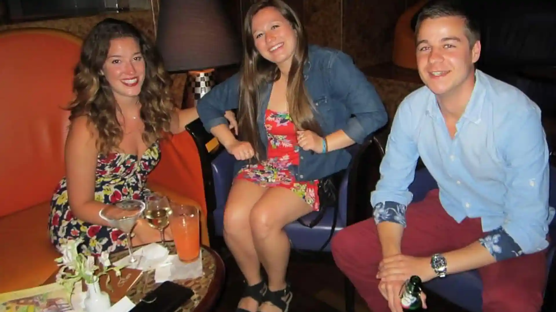 View of three people in lounge on cruise ship.