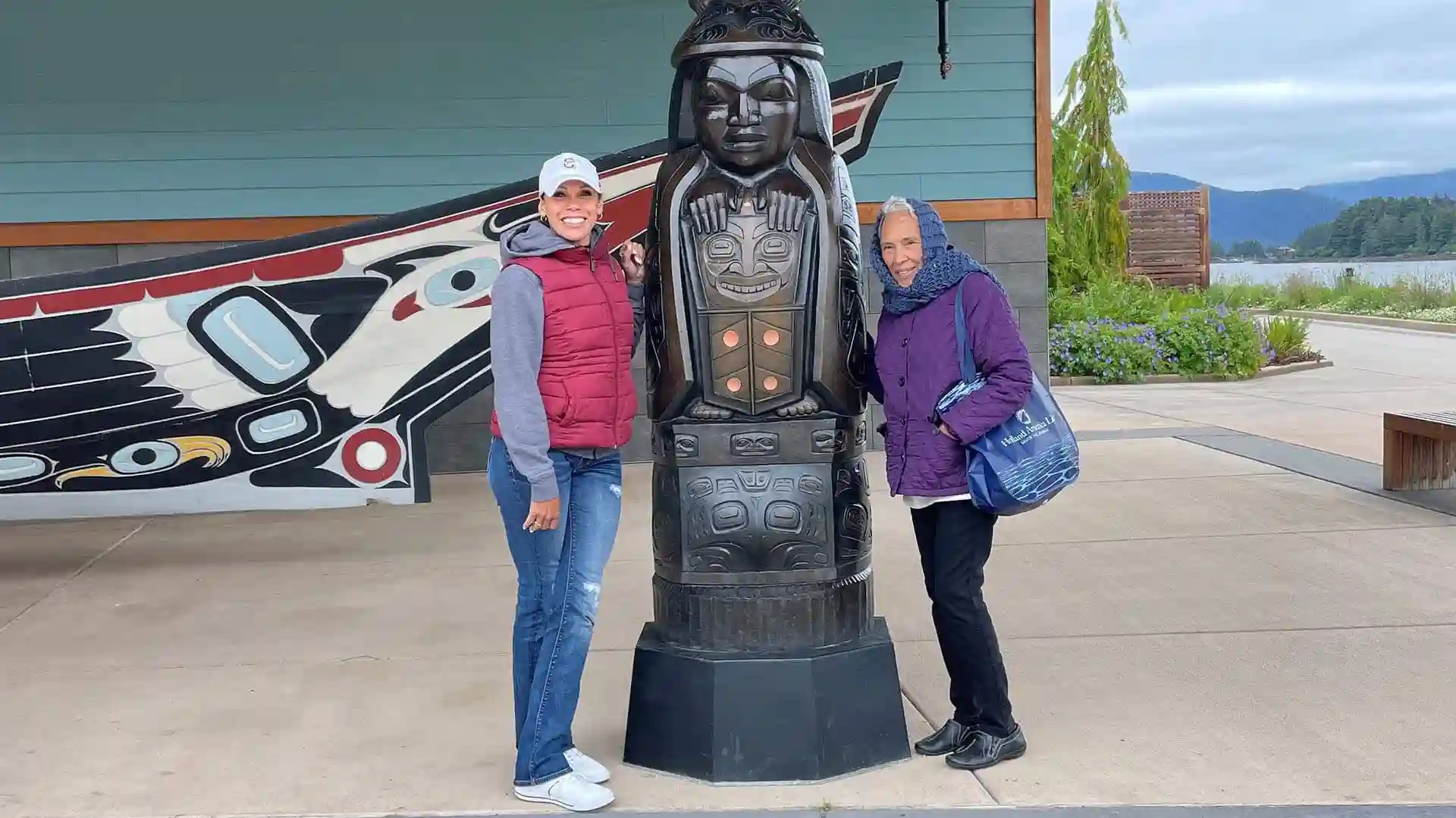 Holland America Line Mother’s Day Cruise View of people standing next to totem pole in Alaska.