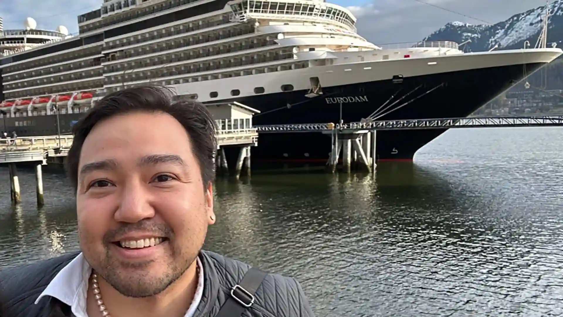 Rico Worl & Holland America Line View of Rico Worl, Alaska Native artist, at Port of Juneau, with Holland America Line cruise ship in background.