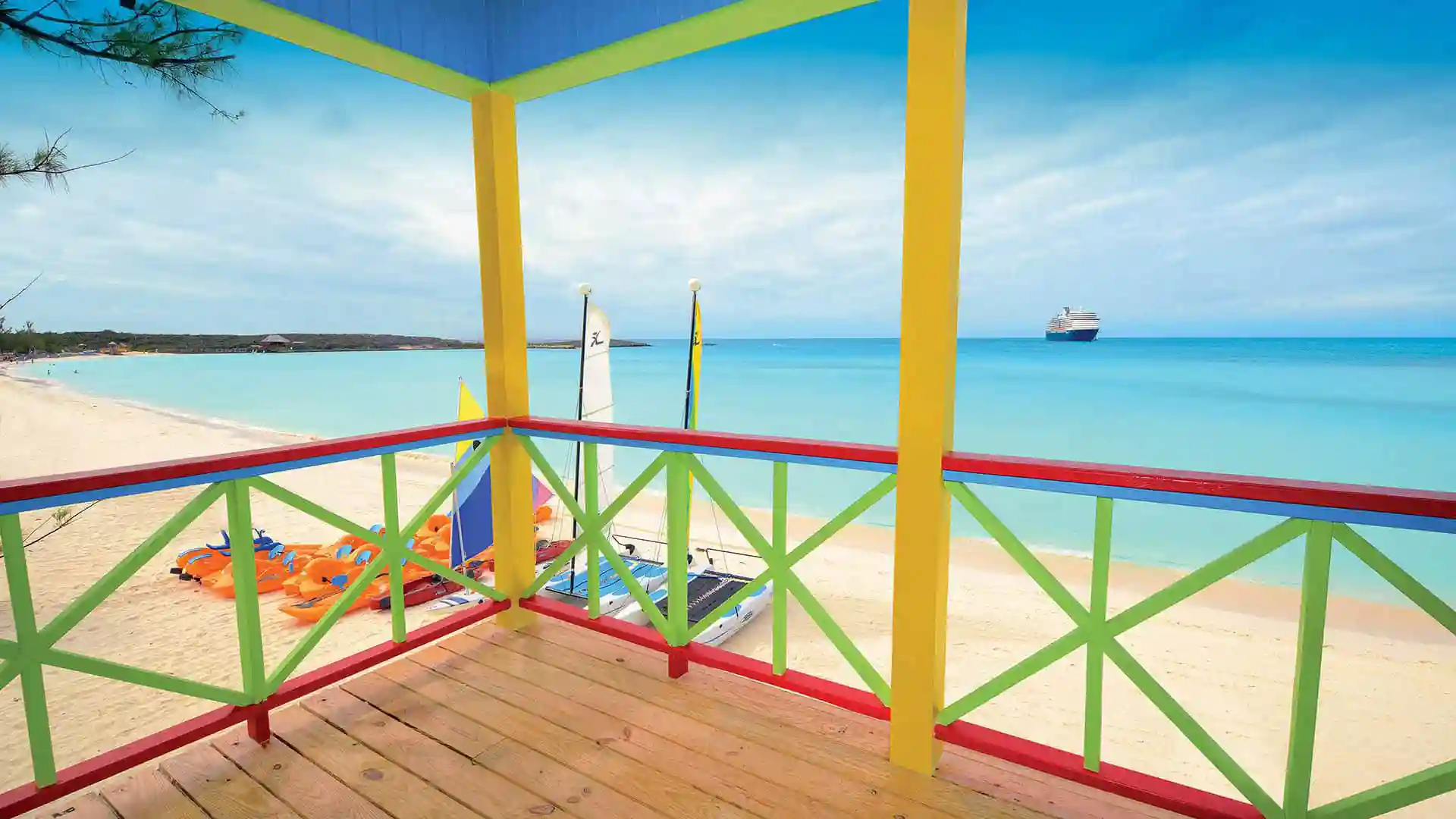 View of ocean and Holland America Line cruise ship from cabana in Half Moon Cay, Bahamas.