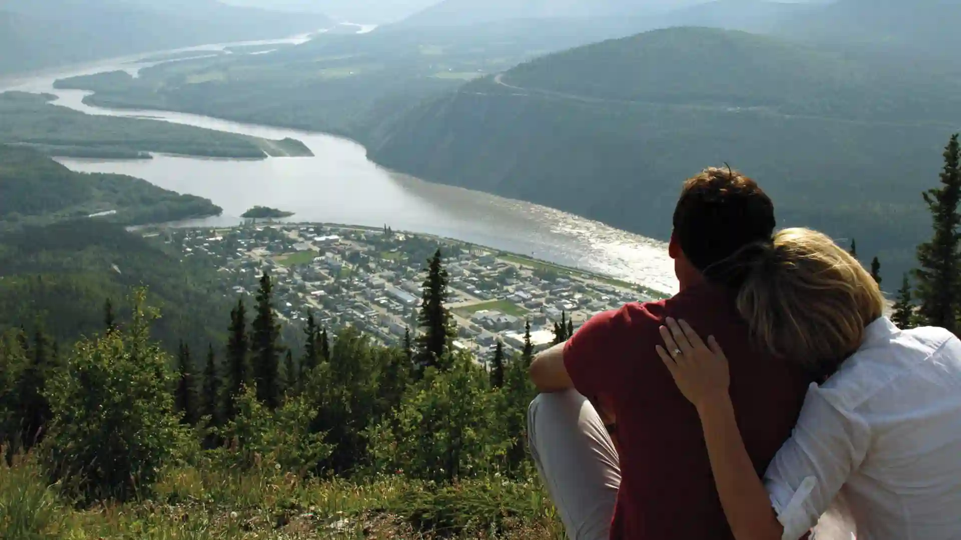 View of people overlooking valley in Canada from hillside.