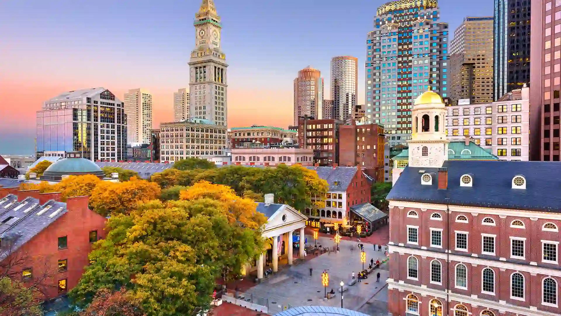 View of tall city buildings and colorful fall foliage.