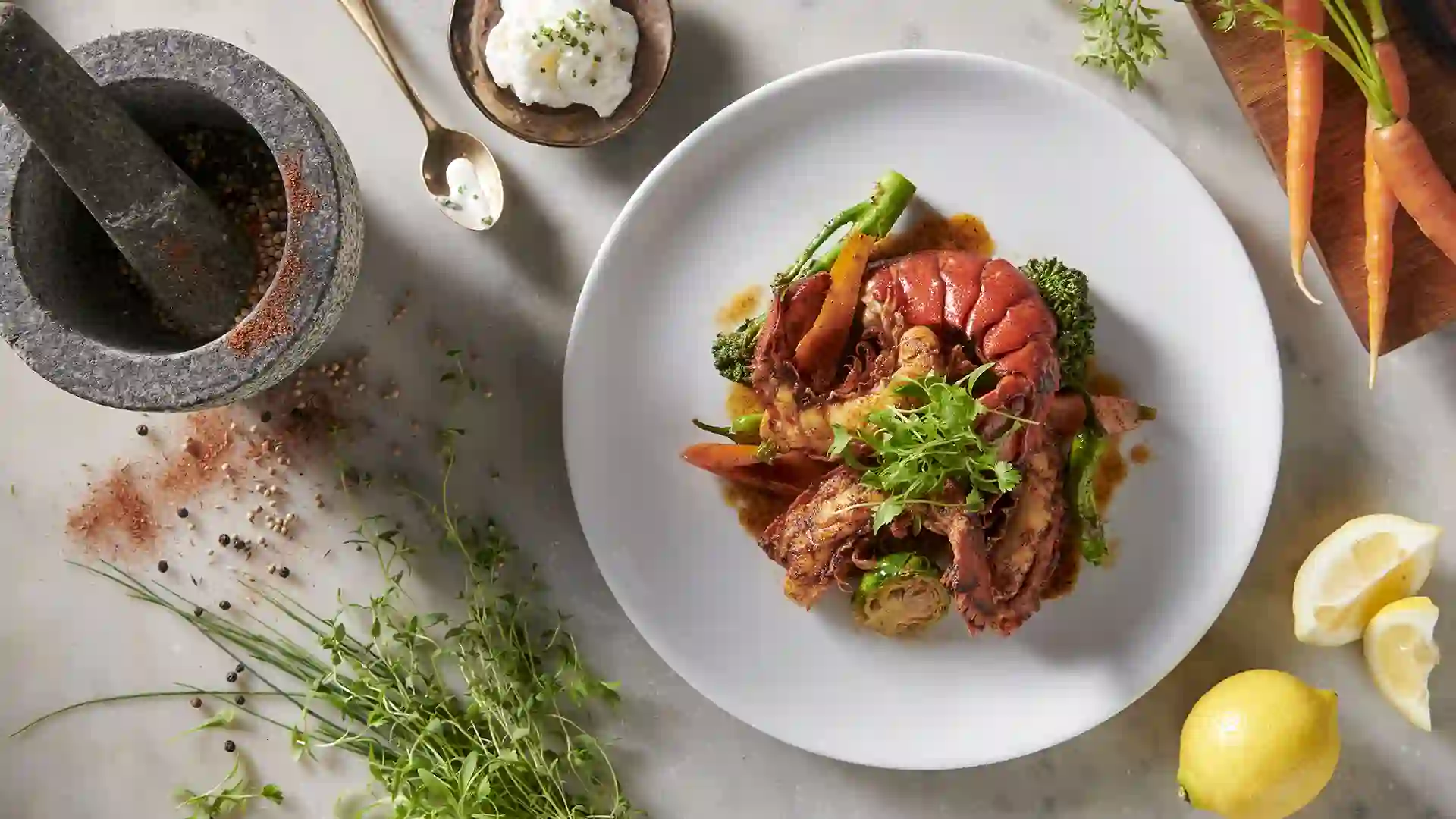 Seafood on plate surrounded by cooking ingredients.