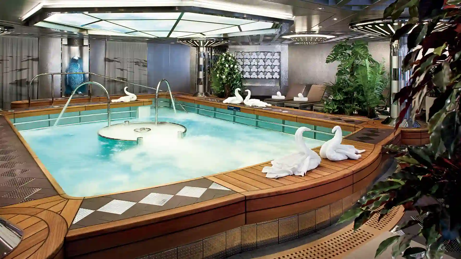 Holland America Line Spa Animal-shaped towels and greenery surround hydro pool .