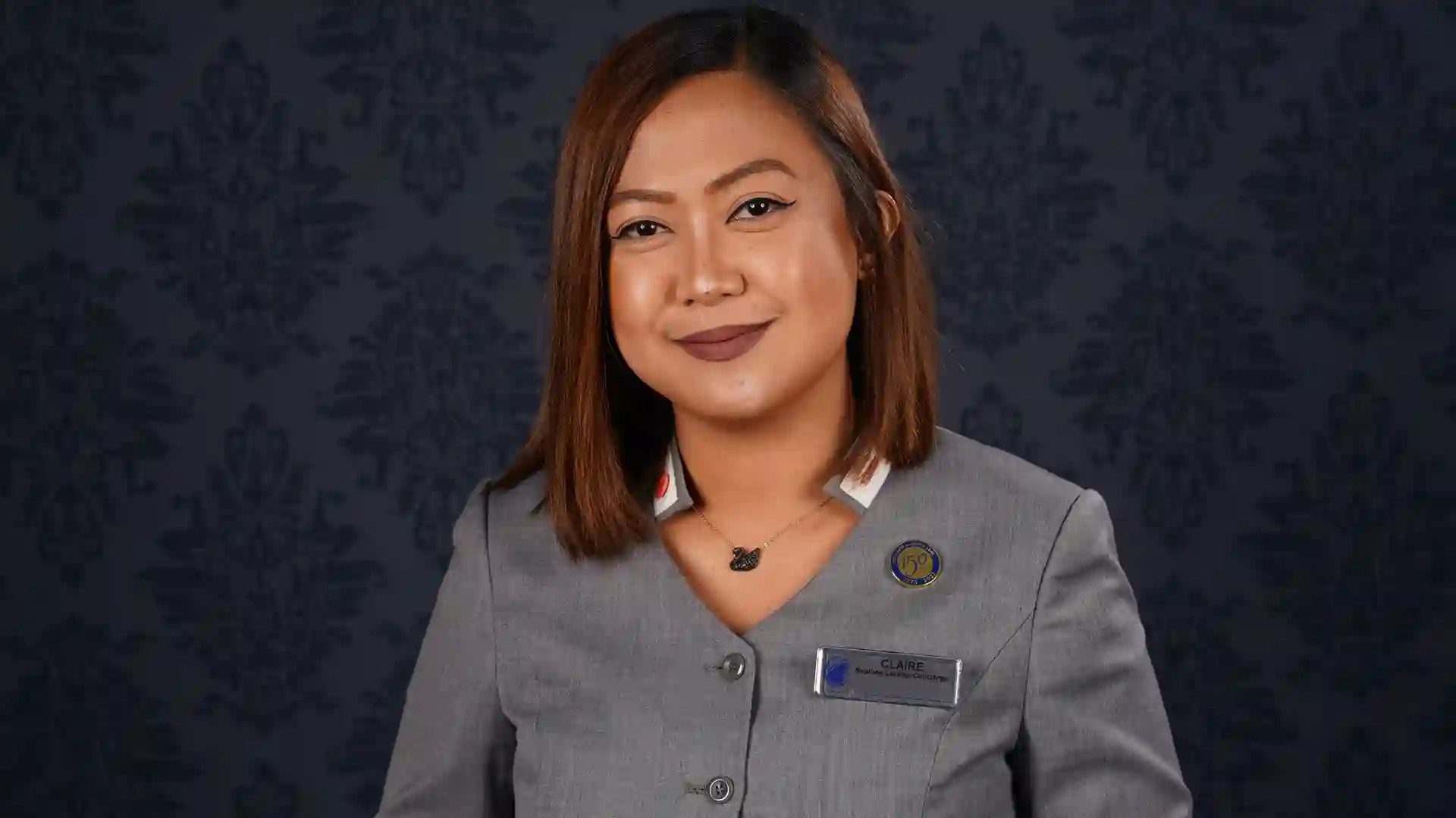 Concierge Customer Service Week Person in gray uniform.