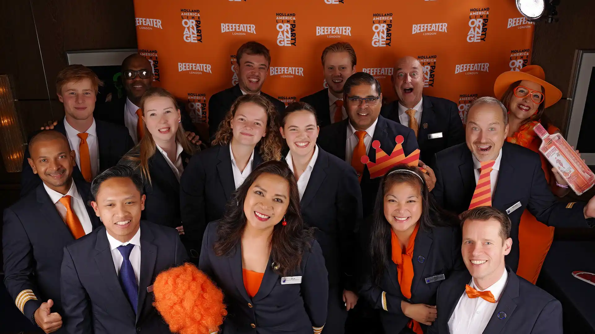 People wearing blue uniforms accented with orange accessories and fun orange photo props.