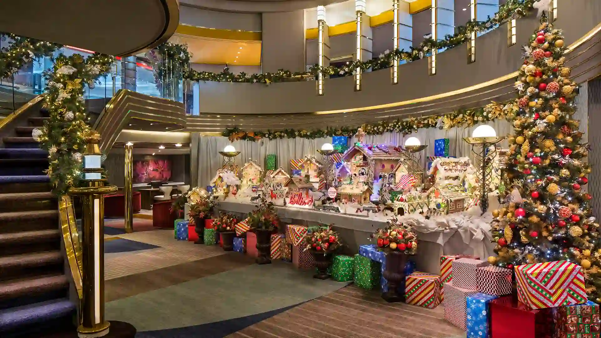 View of colorful gingerbread houses and Christmas tree on Holland America Line cruise ship.
