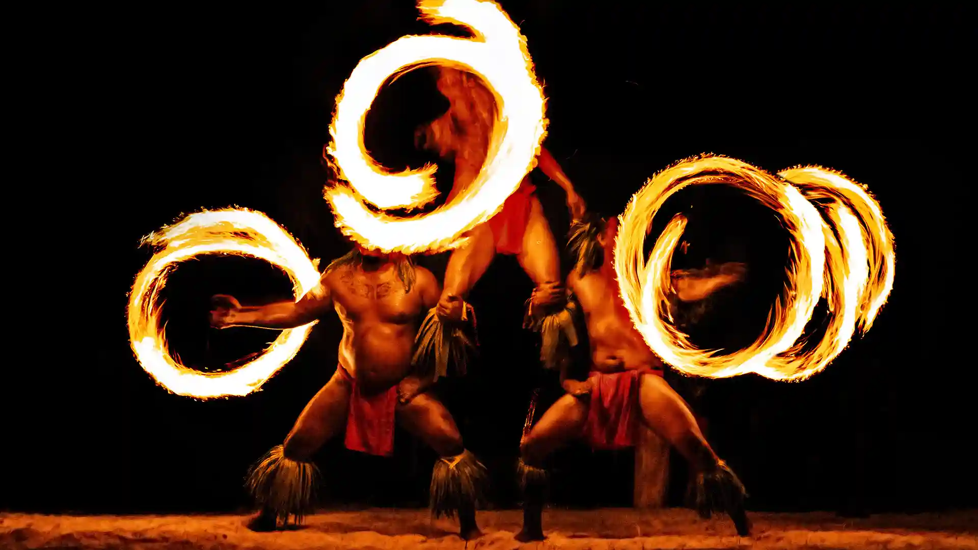 View of performers at a luau with rings of fire.