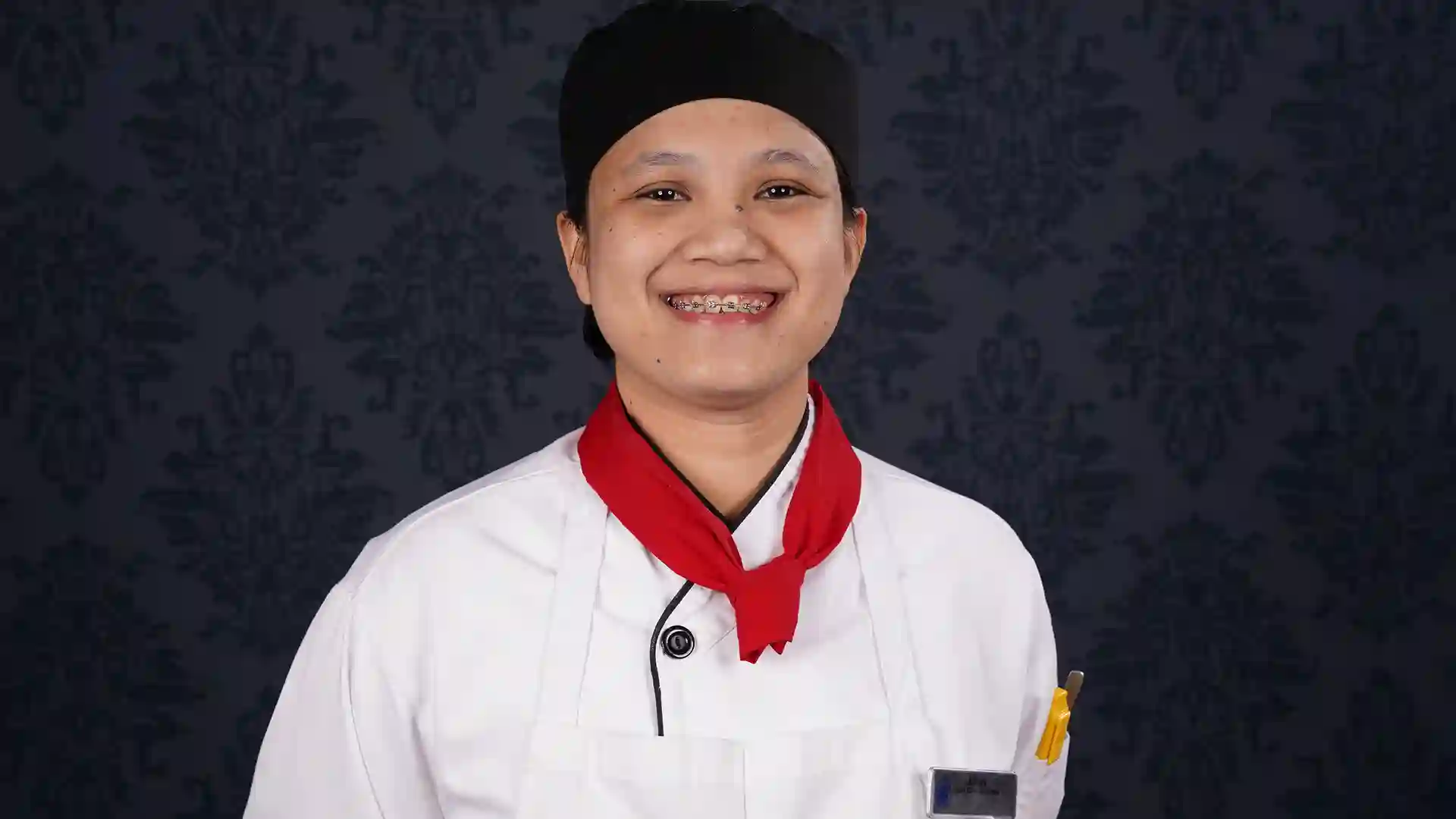 Holland America Line crew member in white chef jacket.