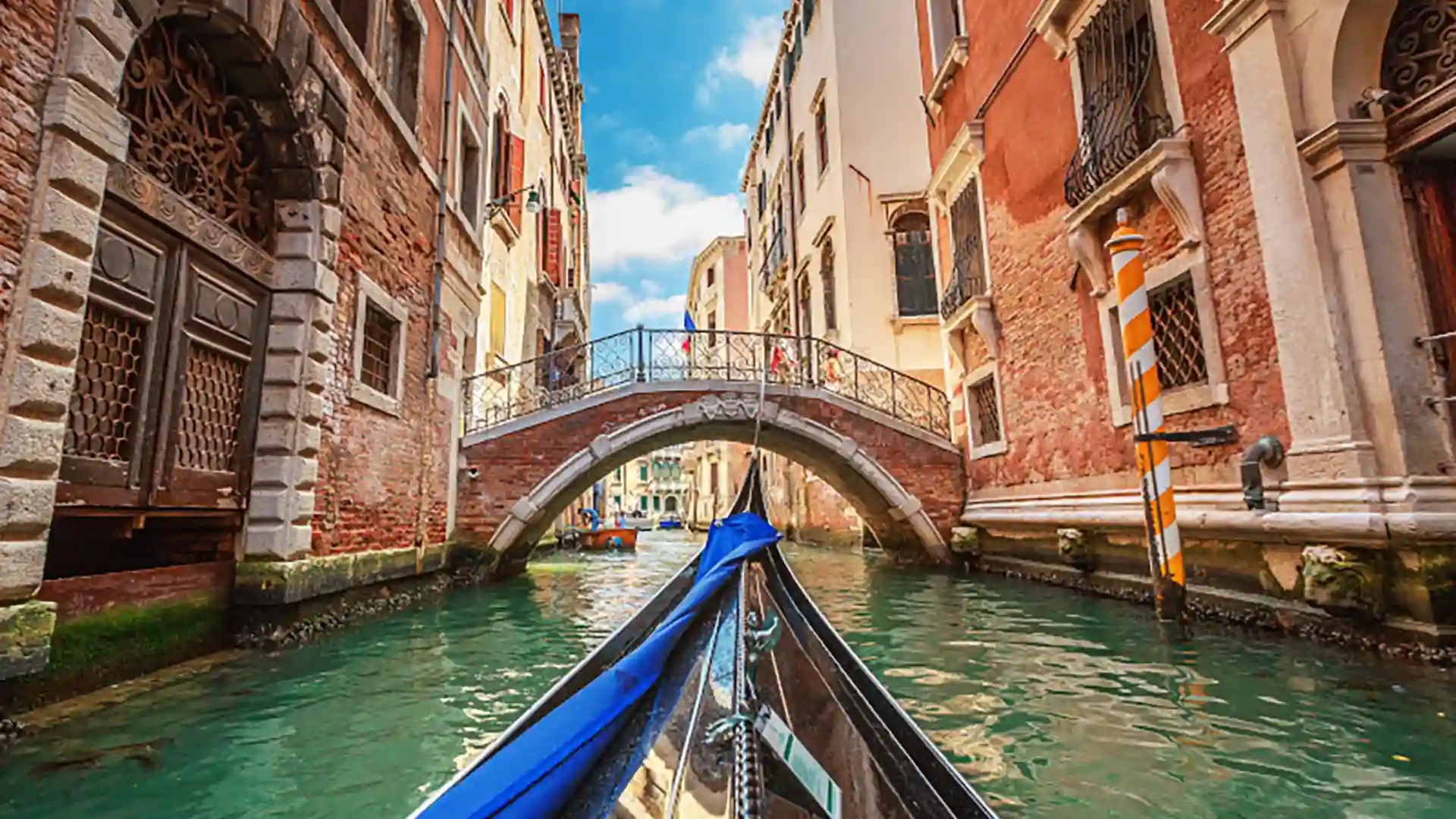 View of Venice buildings and waterway from gondola.