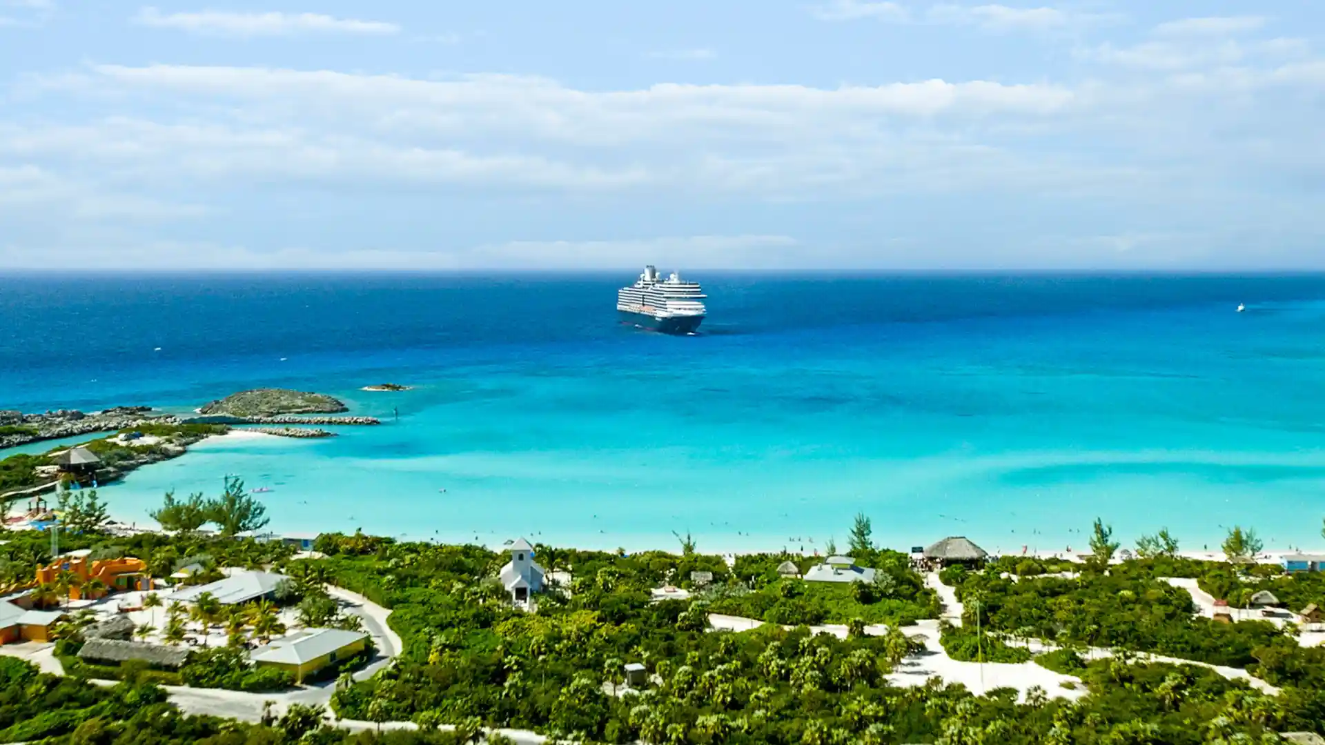 View of Half Moon Cay, a private island in the Bahamas, with Holland America Line cruise ship in the distance.