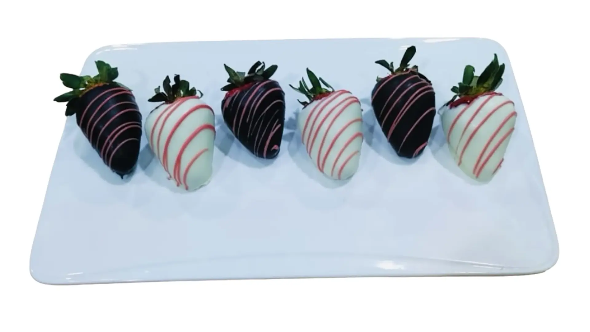 View of chocolate-covered strawberries on a white platter.