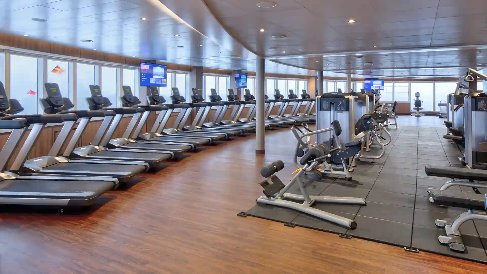 Holland America Line Fitness Center View of fitness center with ocean views on Holland America Line cruise ship.