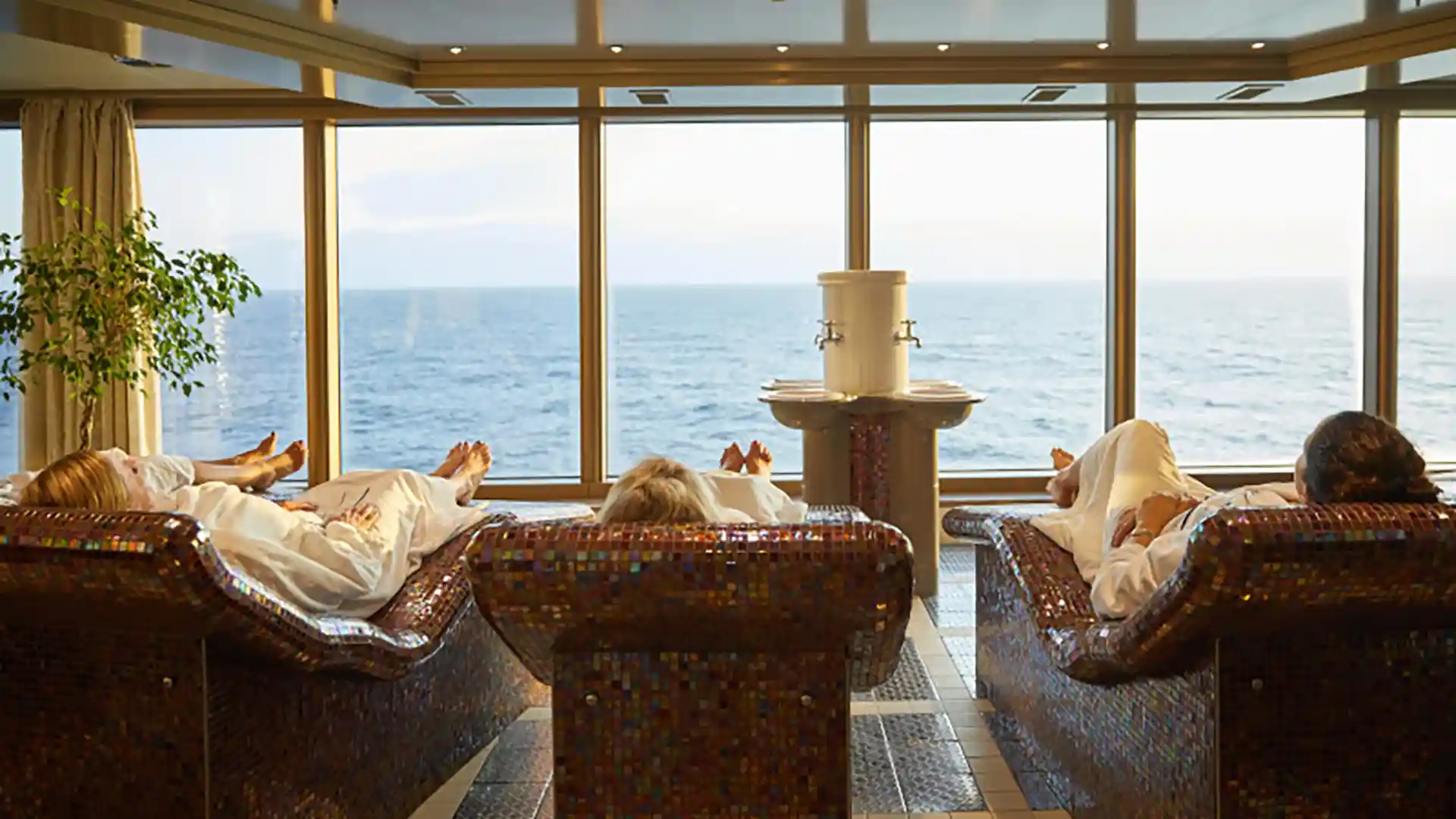 View of people relaxing on loungers with ocean views on Holland America Line ship.