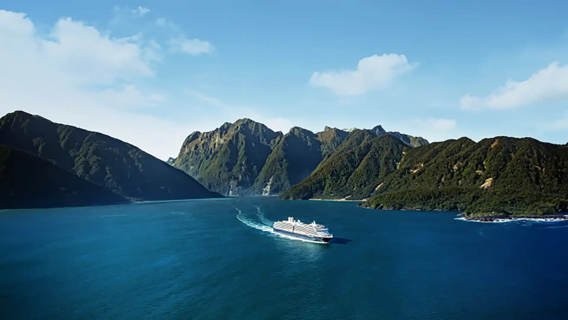 View of Holland America Line cruise ship sailing the Milford Sound in New Zealand.