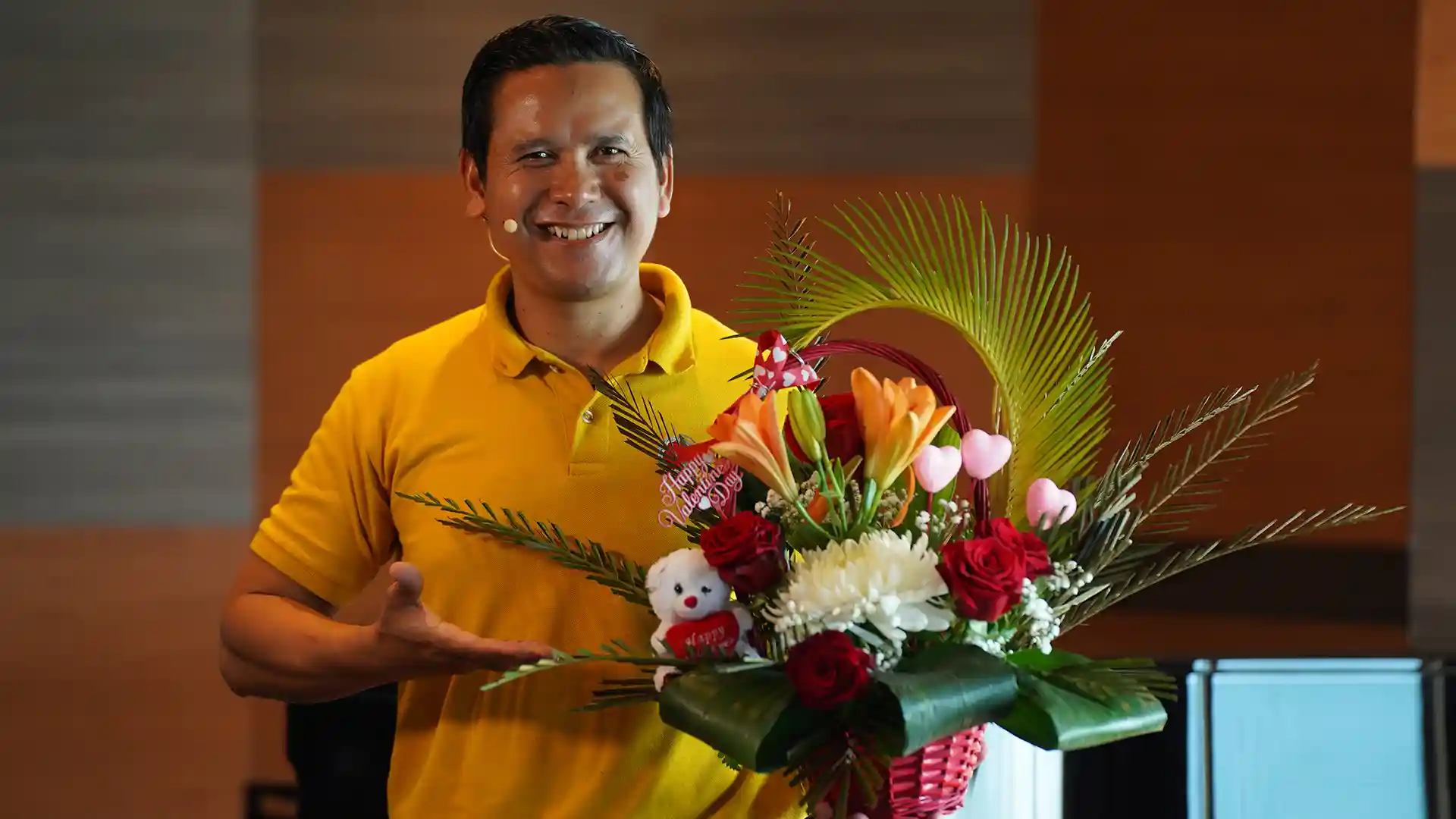 View of Holland America Line crew member holding a Valentine's Day floral arrangement.