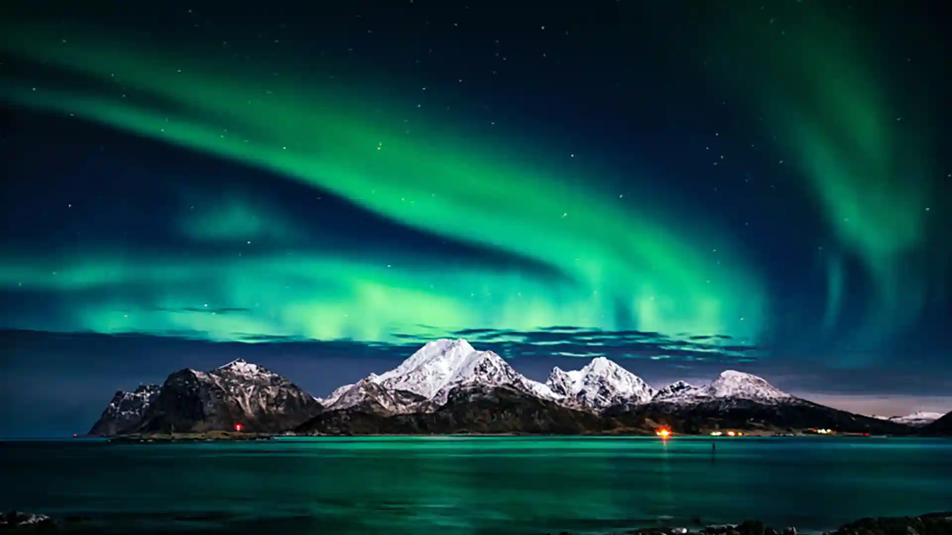 View of northern lights in green hues above Norway.