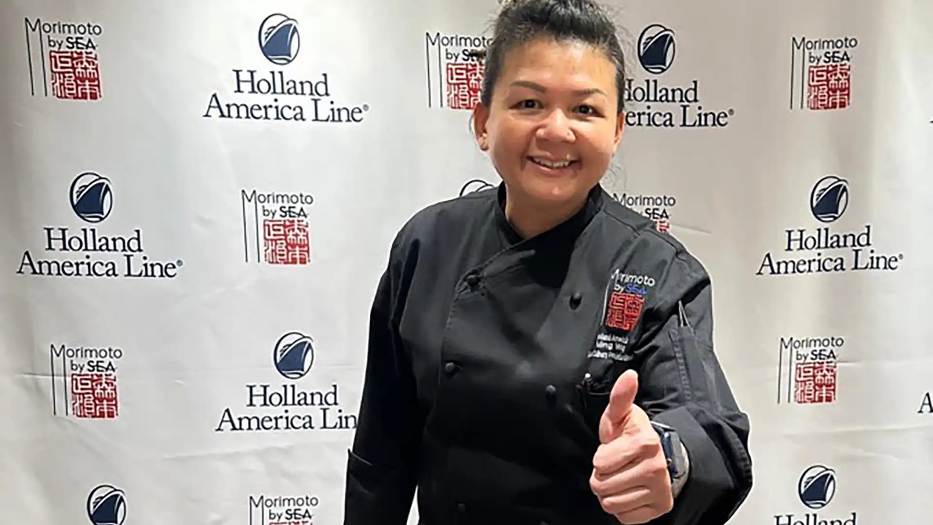 Holland America Line Fleet Executive Chef View of Holland America Line chef sharing thumbs up at restaurant opening on cruise ship.