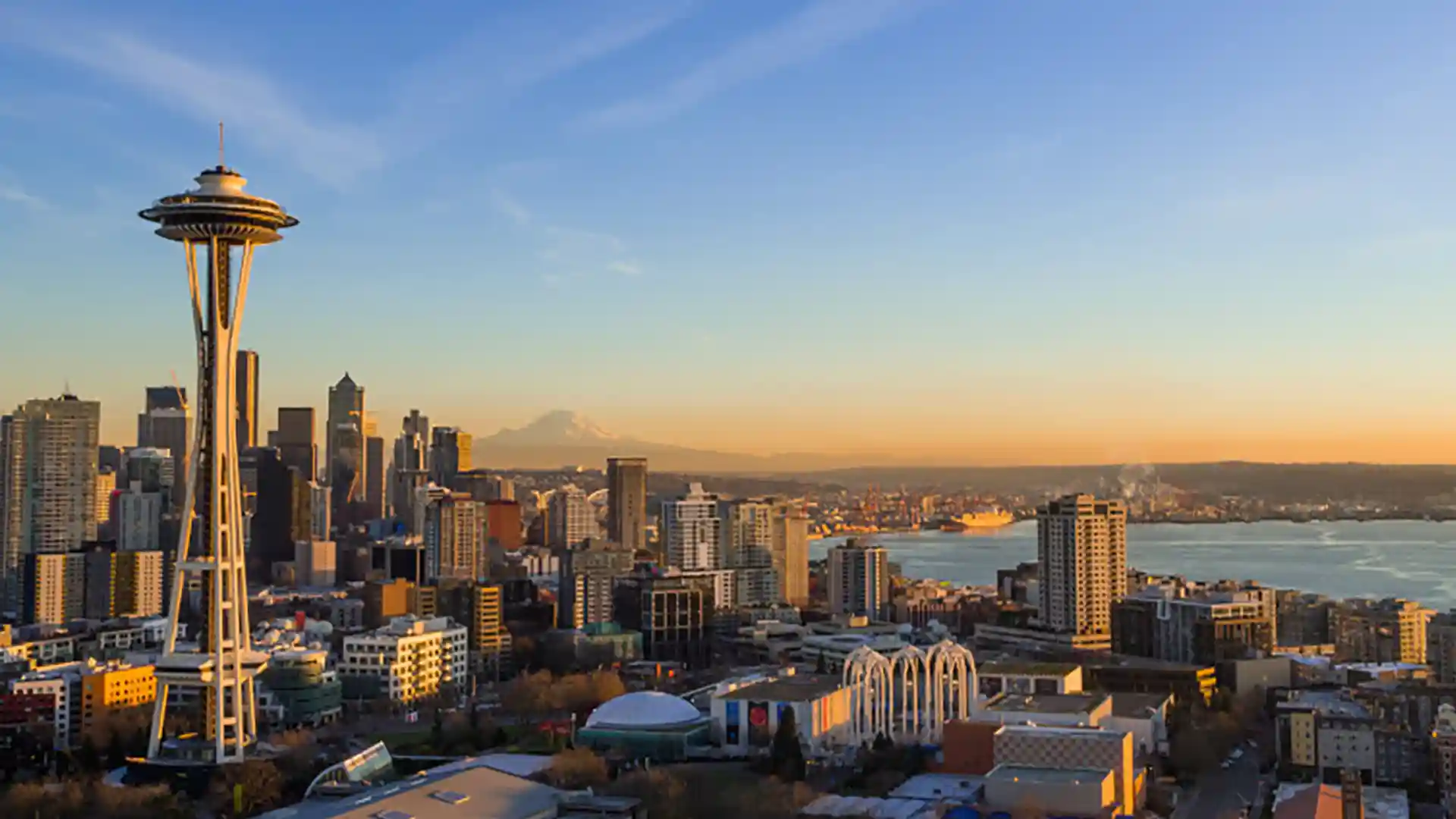 Seattle Space Needle View of Seattle Space Needle and city landscape with Mt. Rainier in background.
