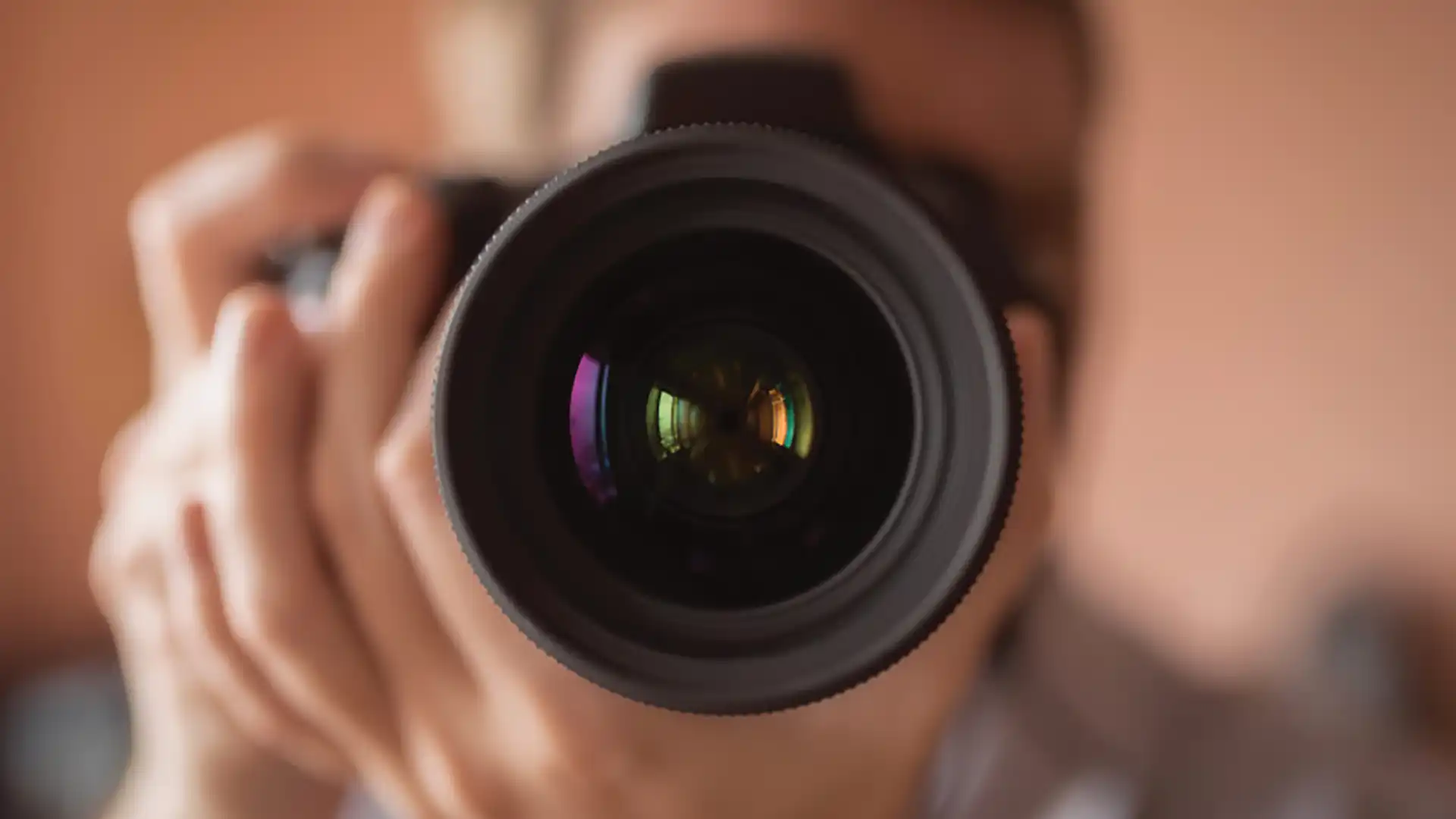 View of person holding a camera with a zoom lens.