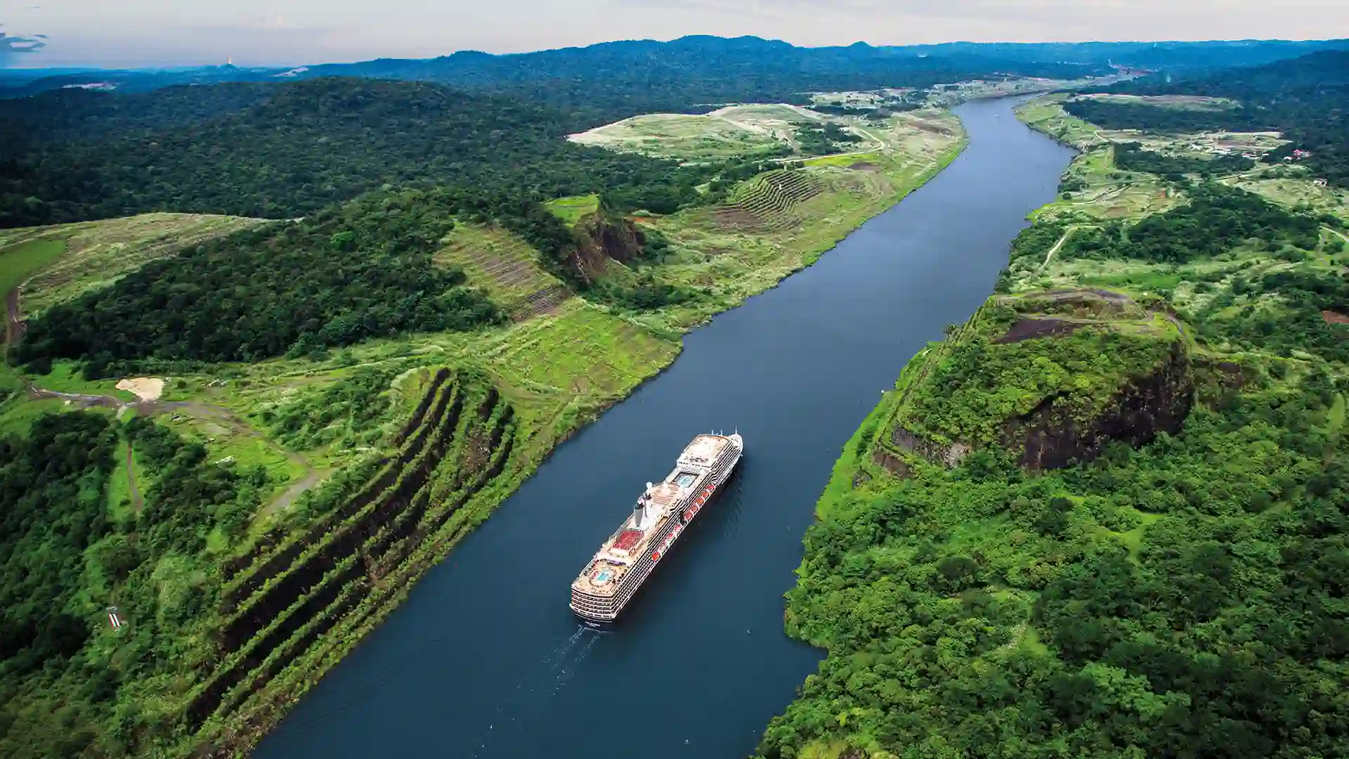 View of Holland America Line cruise ship sailing through Panama Canal.