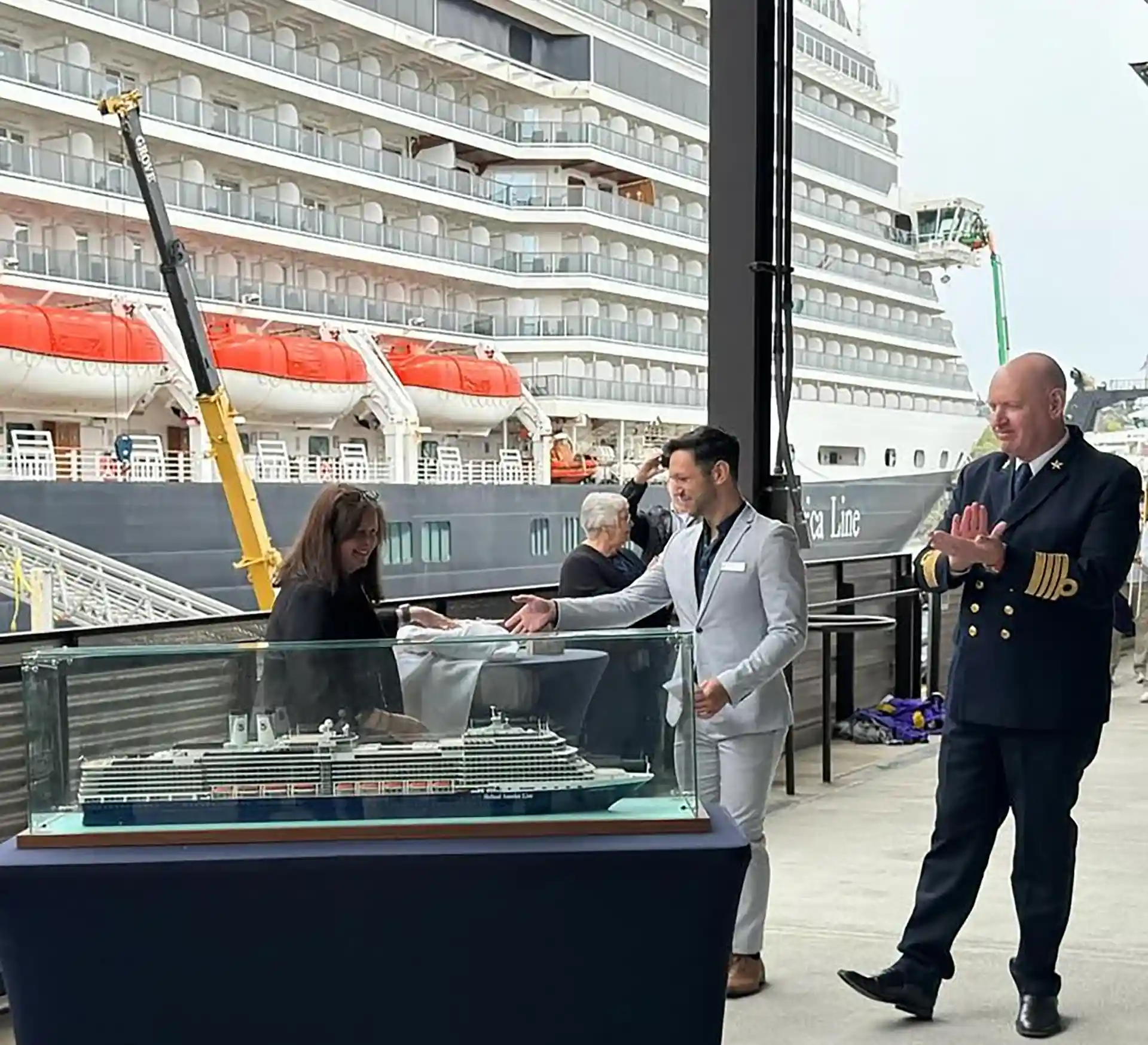 View of Holland America Line crew presenting a model of cruise ship to Port of Seattle.