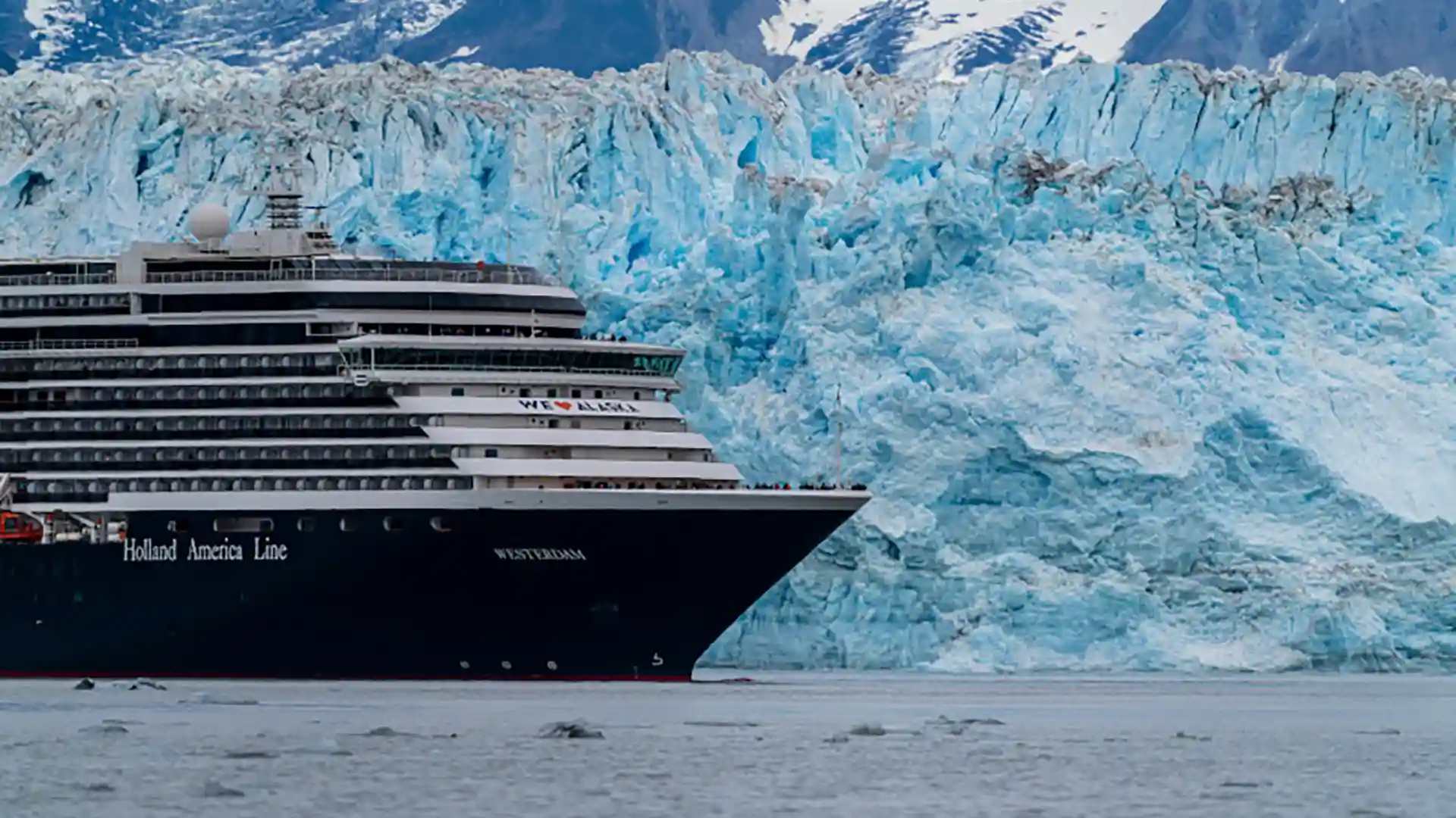 View of Holland America Line ship cruising by Hubbard Glacier in Alaska.