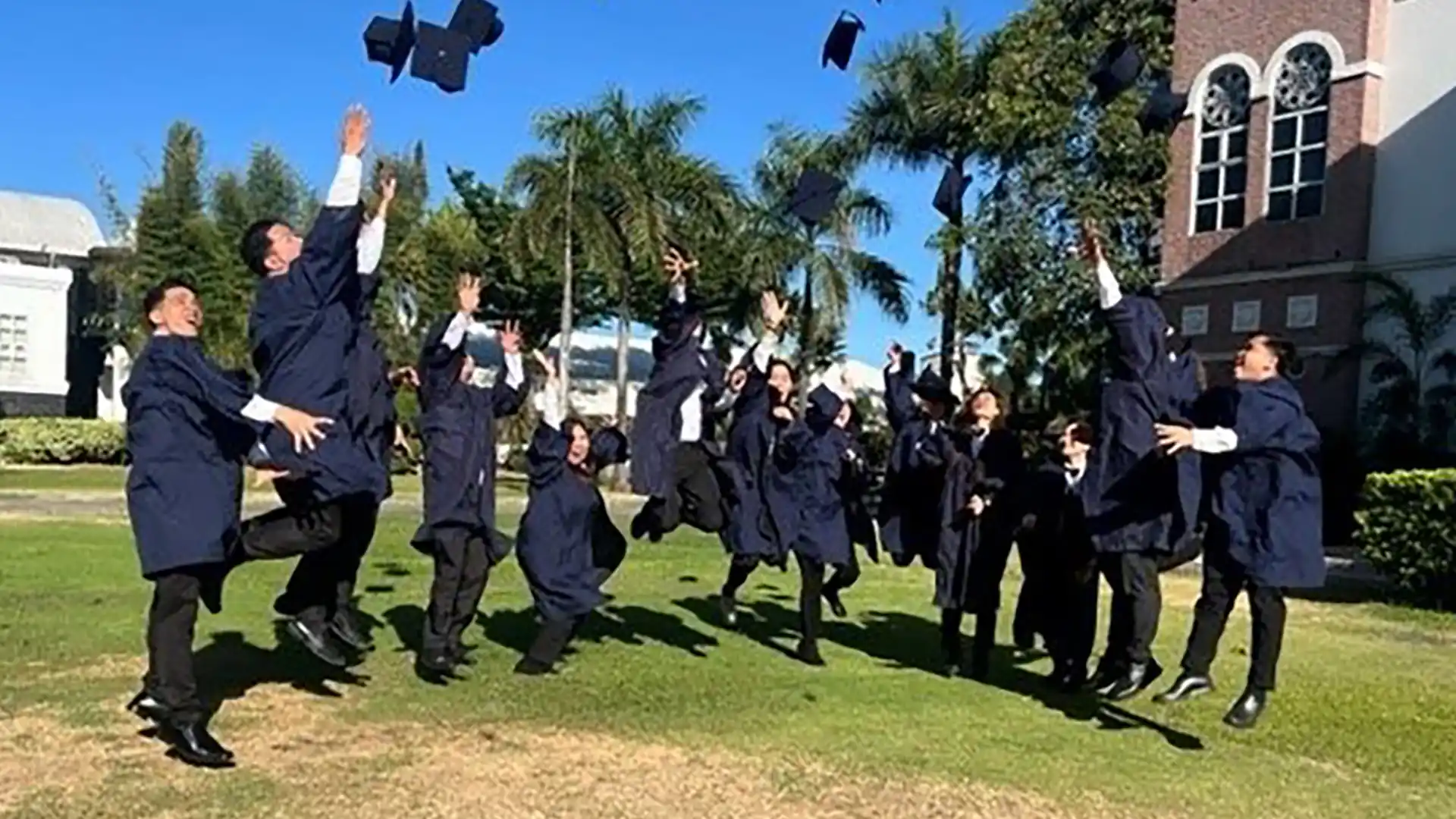 Holland America Line Graduation View of students throwing caps in the air after graduating from a Holland America Line training program.