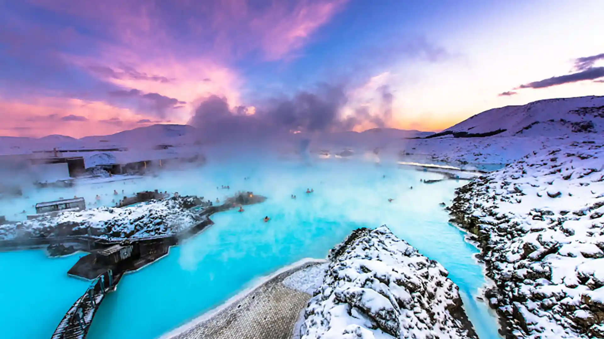 Iceland Cruise Vacation Hot spring surrounded by snow-covered land in Iceland.