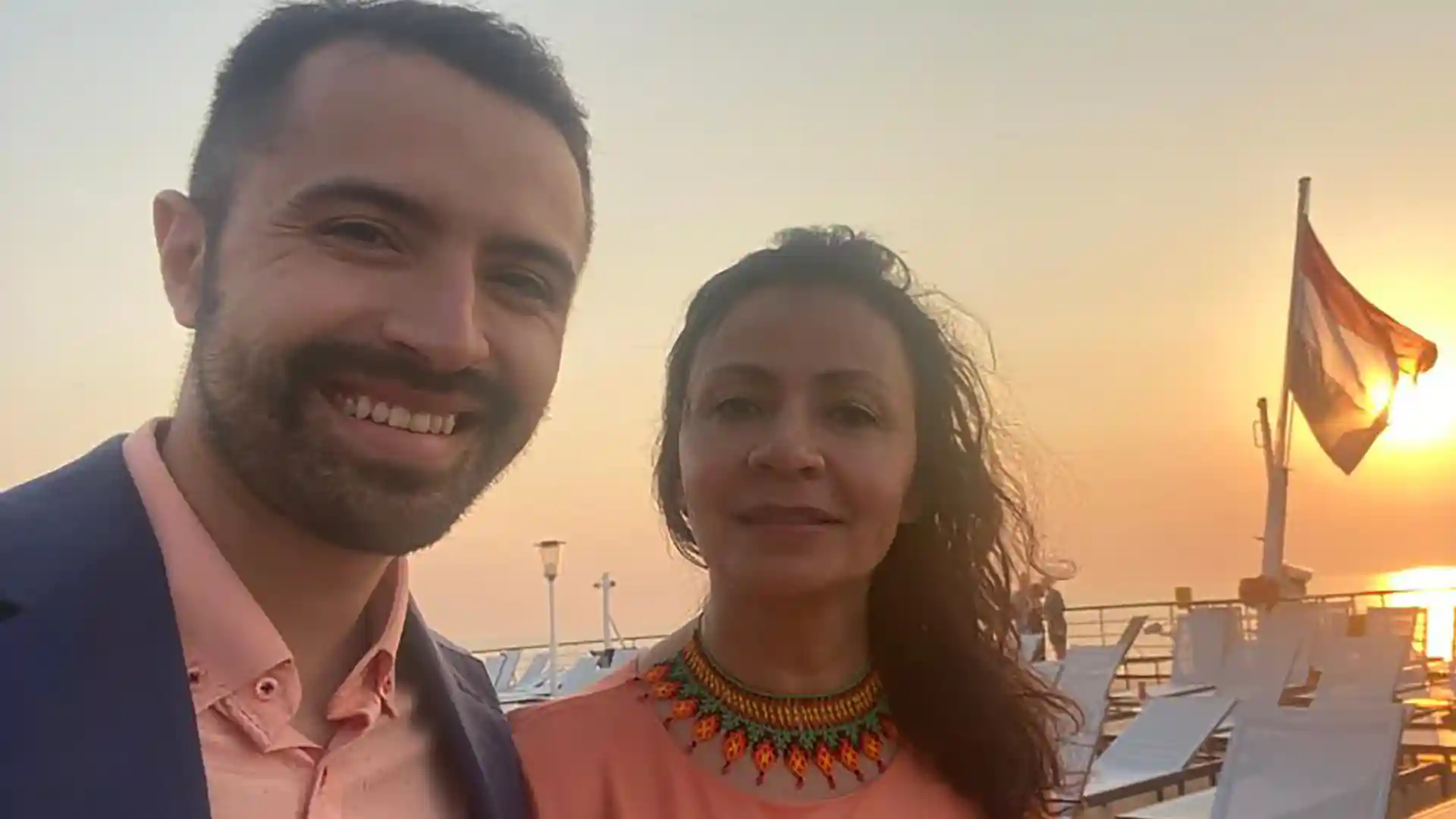 View of people on Holland America Line cruise ship at sunset in Europe.