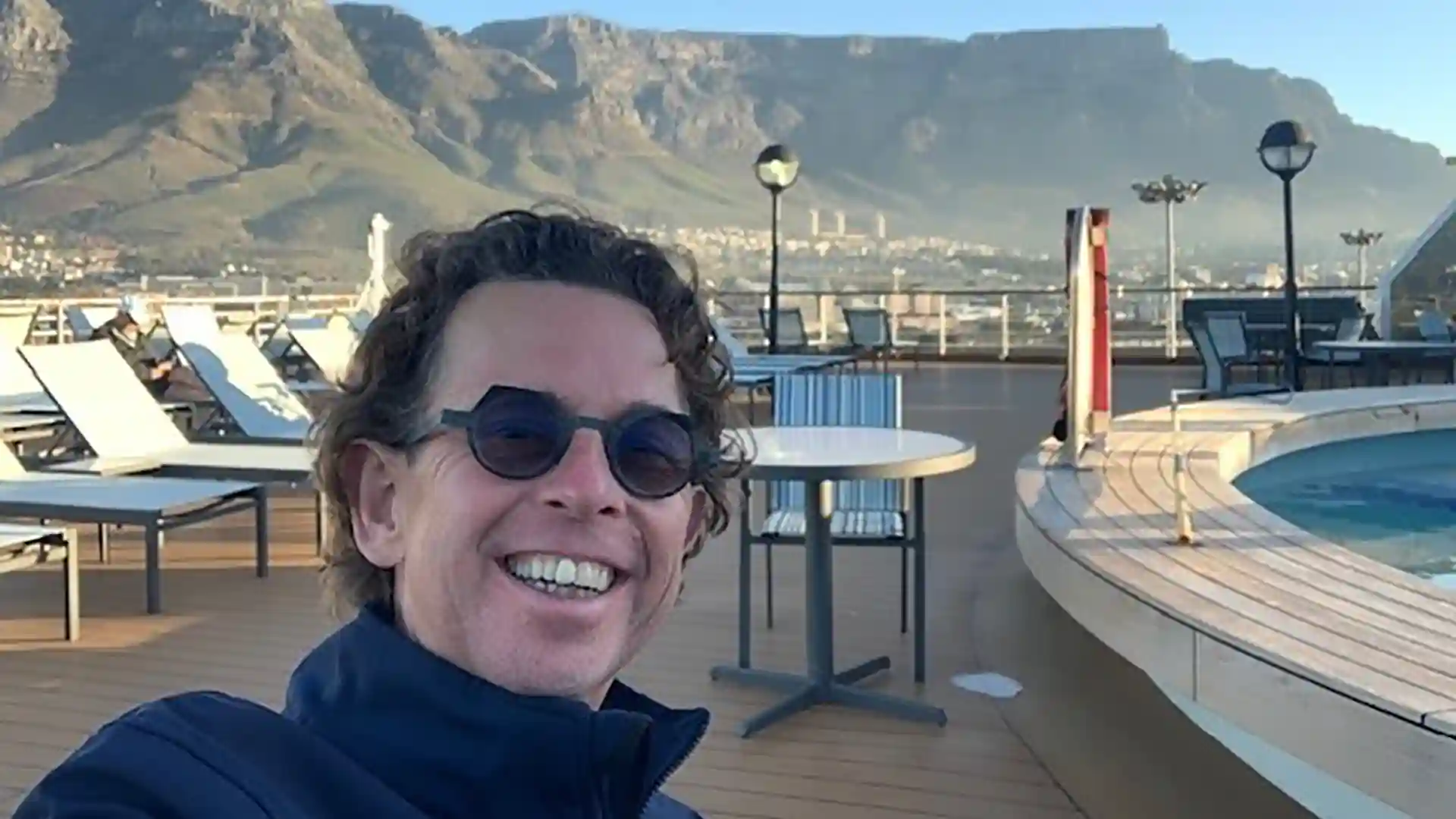Incredible Grand Voyage Views View of Holland America Line General Hotel Manager near pool on cruise ship.