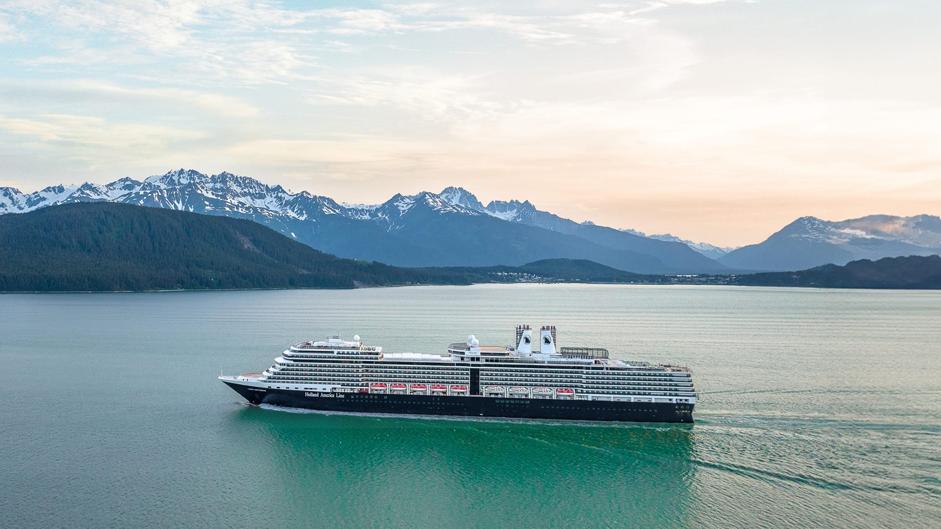 061025_SEO Blog_The Best Time to Cruise to AK_Ship in Spring Holland America cruising Alaska on blue-green water with glacier ice and brown mountains in the background.