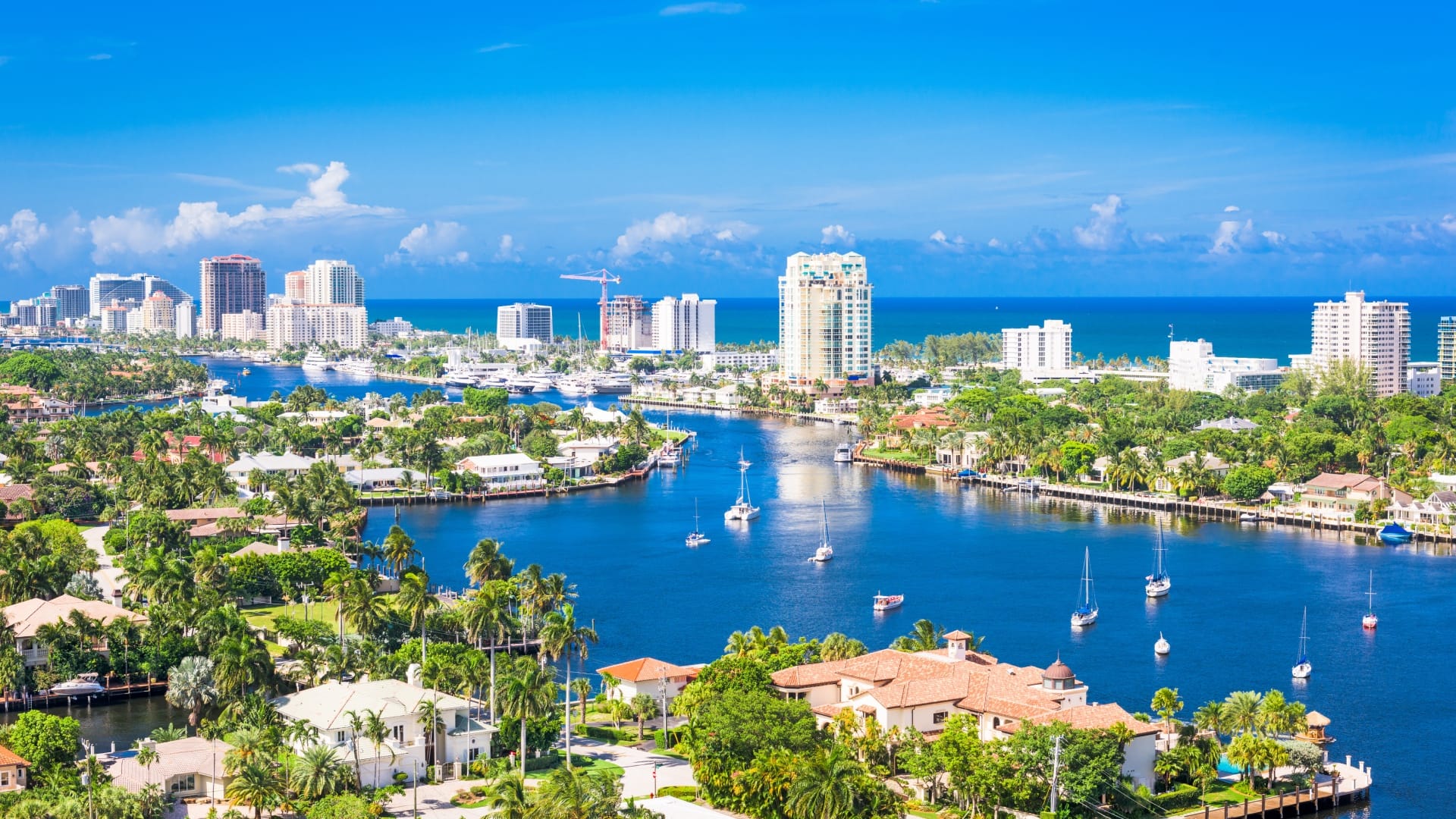Yachts bob on a blue waterway in Ft. Lauderdale, the Venice of North America.