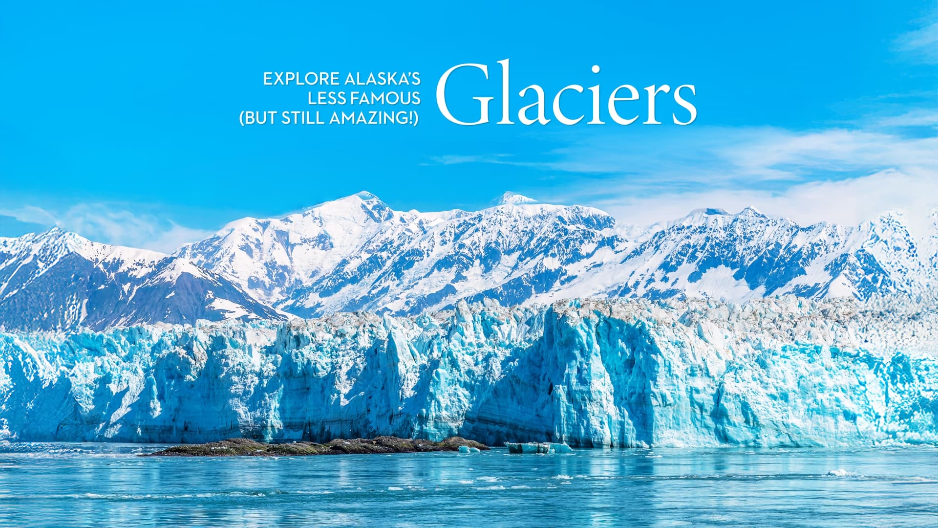 Vivid blue Alaska glacier in front of snow-capped mountains with the text Explore Alaska’s Less Famous (But Still Amazing) Glaciers