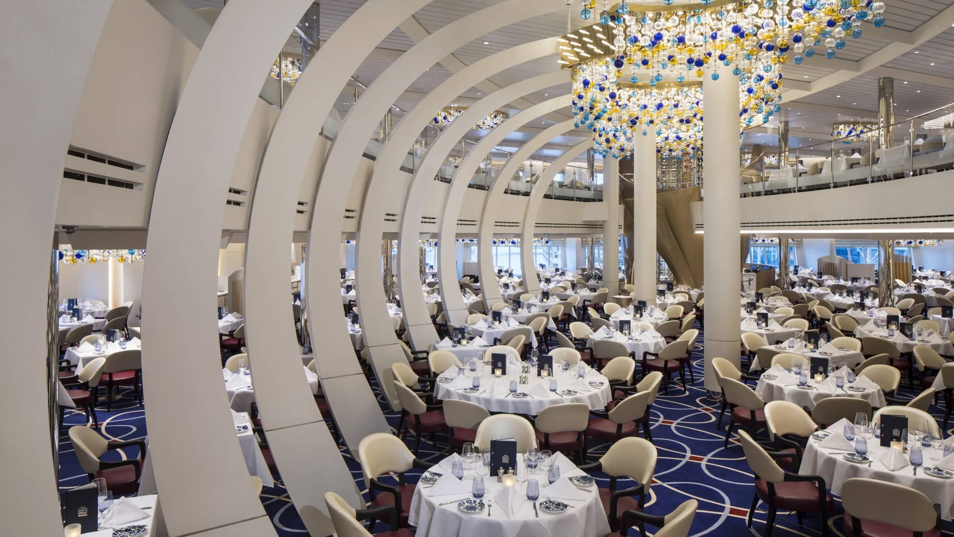 main-dining-room-blog-1 Spacious main dining room with curved architecture and decorative chandeliers.