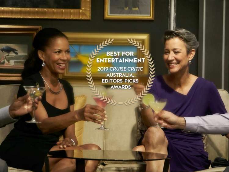 two couples toast drinks in a bar with an award for 2019 best entertainment from Cruise Critic Australia, editor's picks award