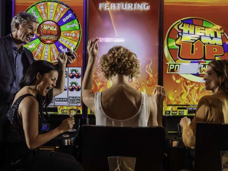 women playing slot machine