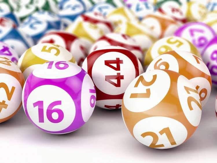 multicolored bingo balls displayed across a table surface