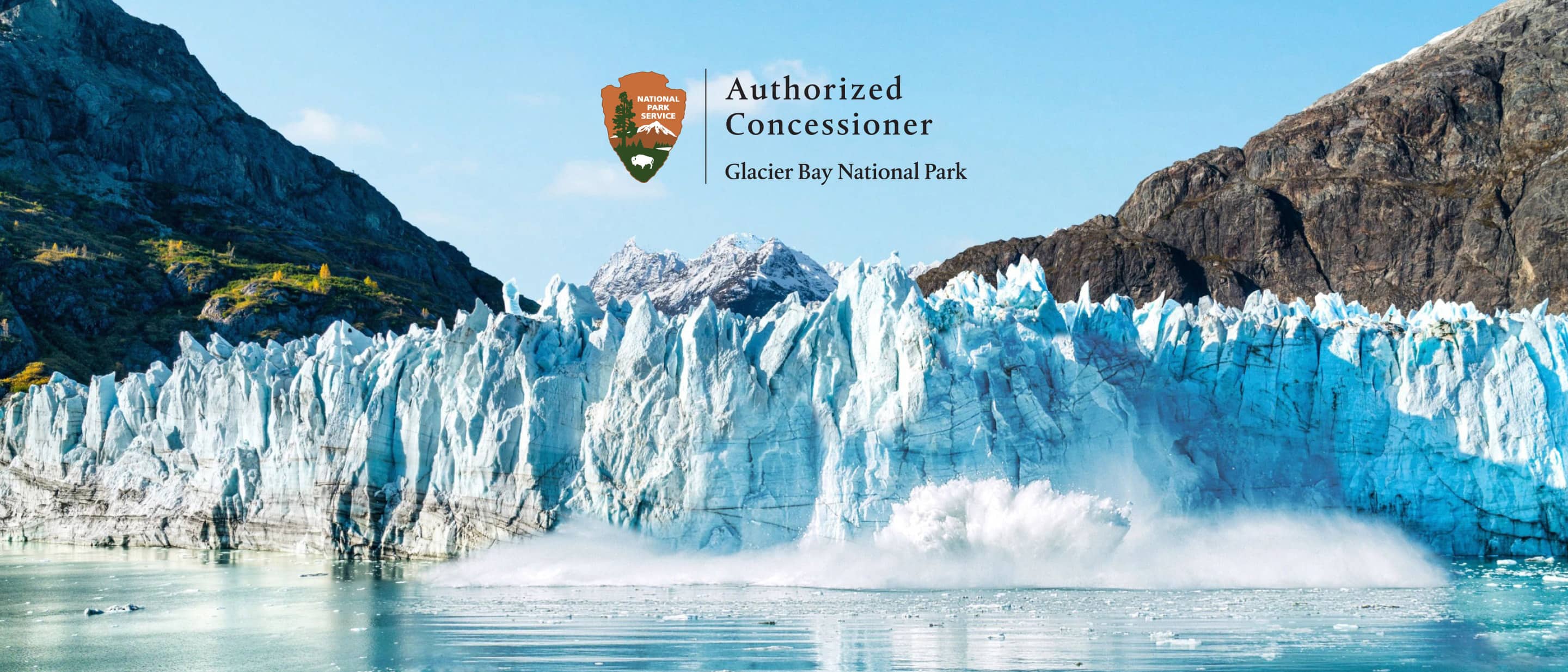 Majestic glaciers meet the water in Glacier Bay National Park, Alaska, framed by rugged mountains under a clear sky