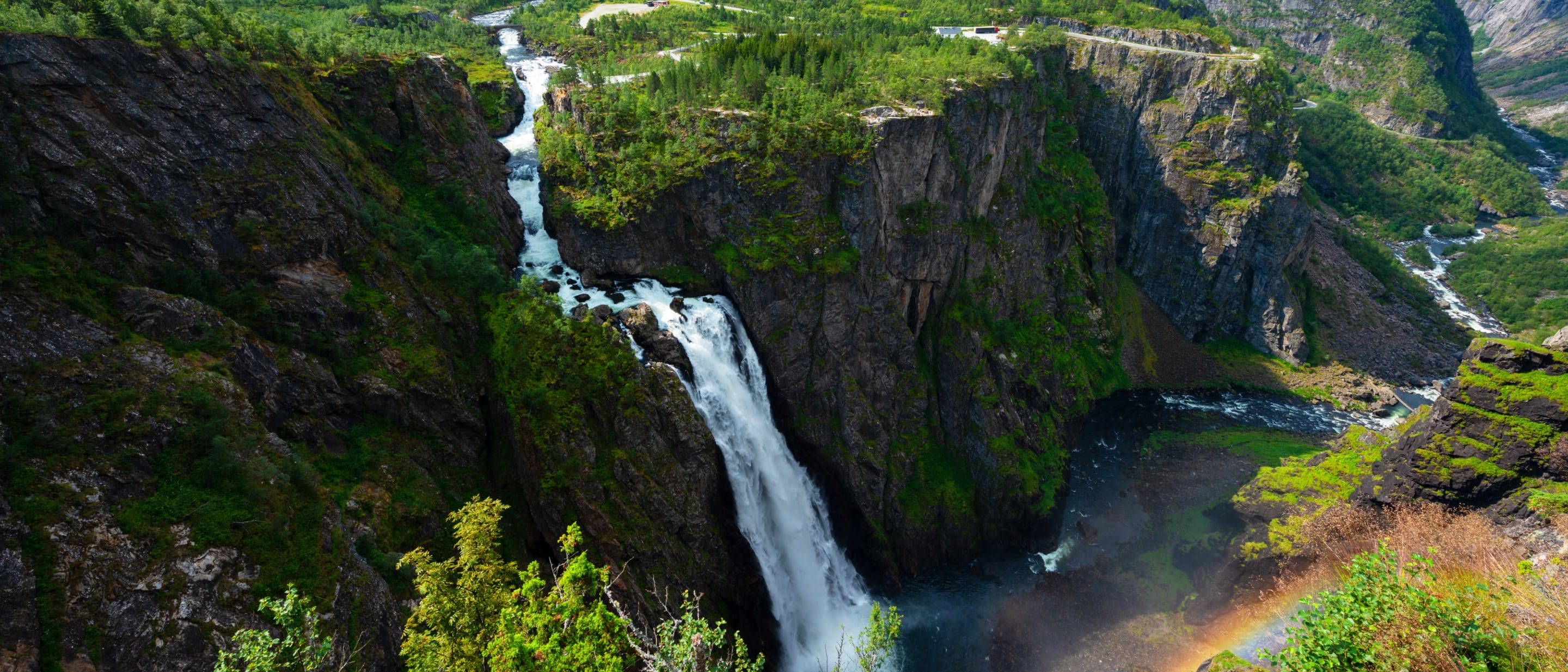 Vøringfossen waterfall in Norway with a rainbow at the base.