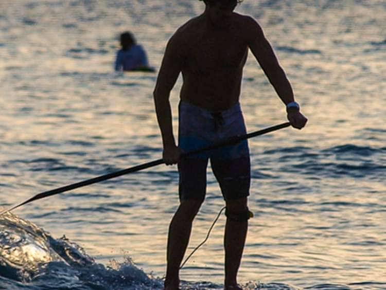Man paddle boarding in Honolulu, Hawaii on a Hawaii cruise