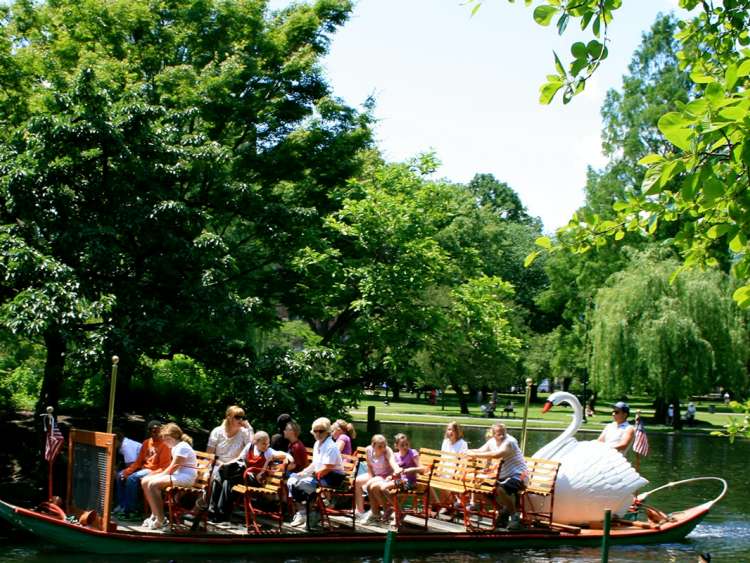 People riding swan boat at Boston Public Gardens