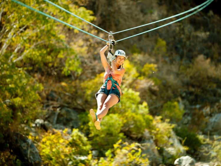 A smiling woman on a zipline on a Panama Canal cruise excursion