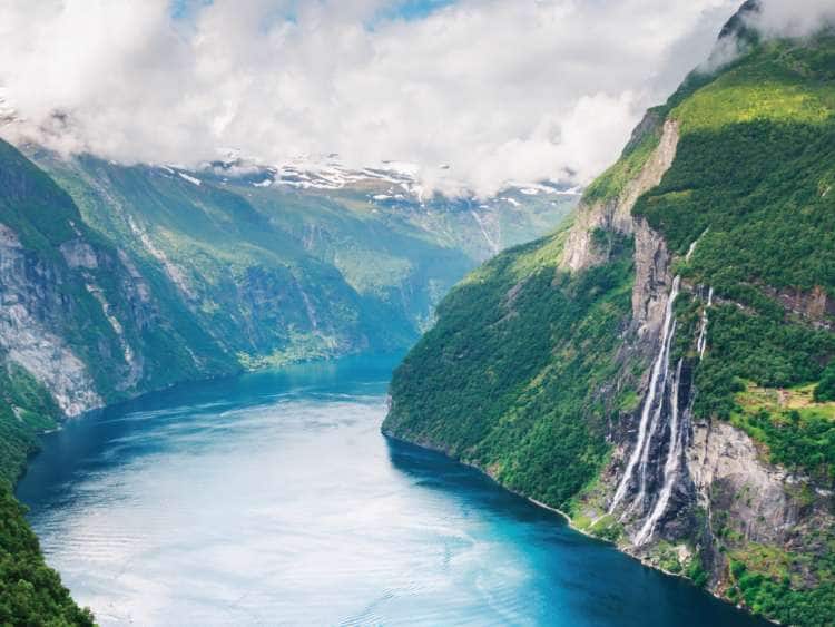 An image of cruising by the Geirrangerfjord in Norway.