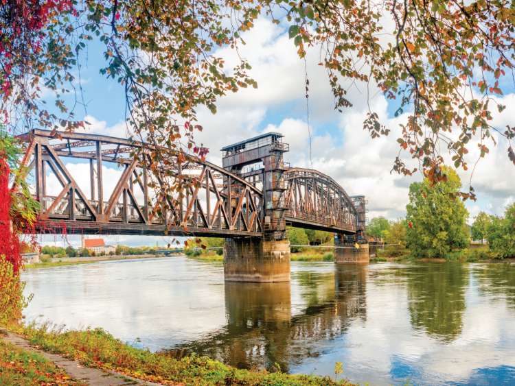 Autum landscape of old railway bridge over the Elbe River in Magdeburg, Germany